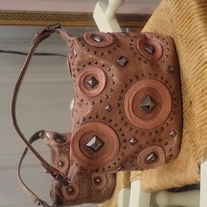 Pink leather and cowhide purse with gunmetal stud accents.